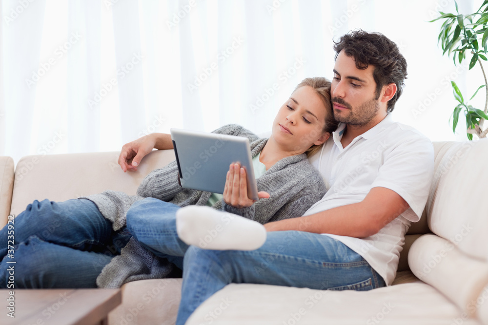 Lovely couple using a tablet computer Lovely couple using a tablet computer