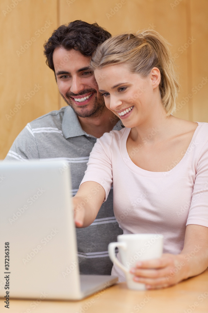 Portrait of a couple using a notebook while having tea Portrait of a couple using a notebook while having tea