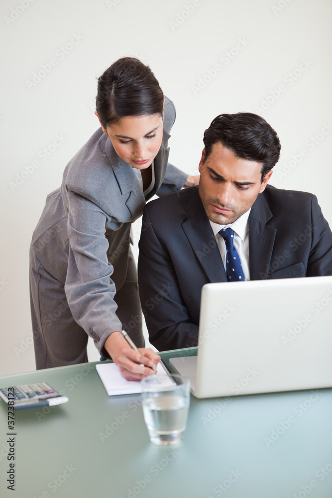 Portrait of a good looking business team working with a laptop Portrait of a good looking business team working with a laptop