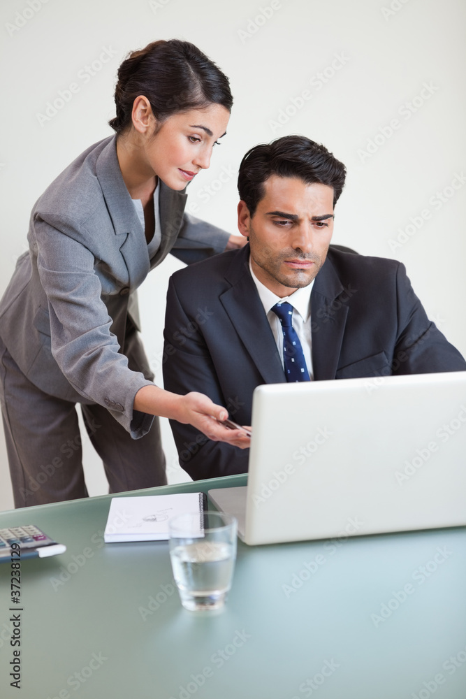 Portrait of a good looking business team working with a notebook