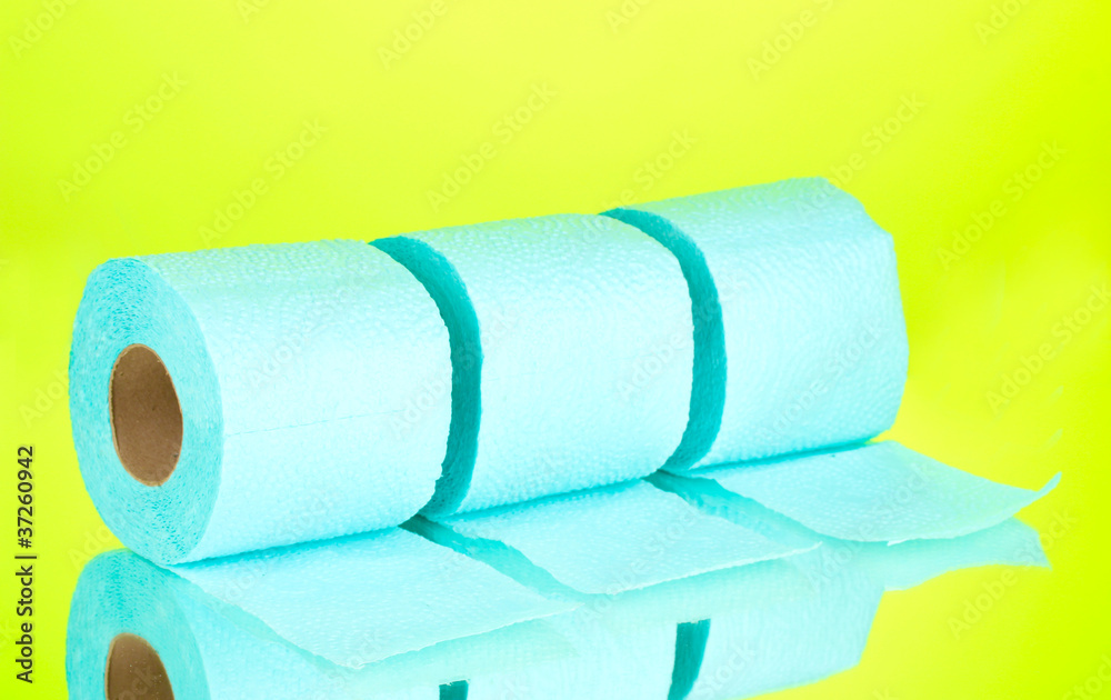 Obraz premium blue rolls of toilet paper on green background