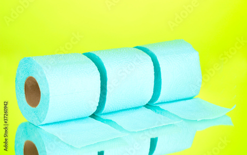 blue rolls of toilet paper on green background photo