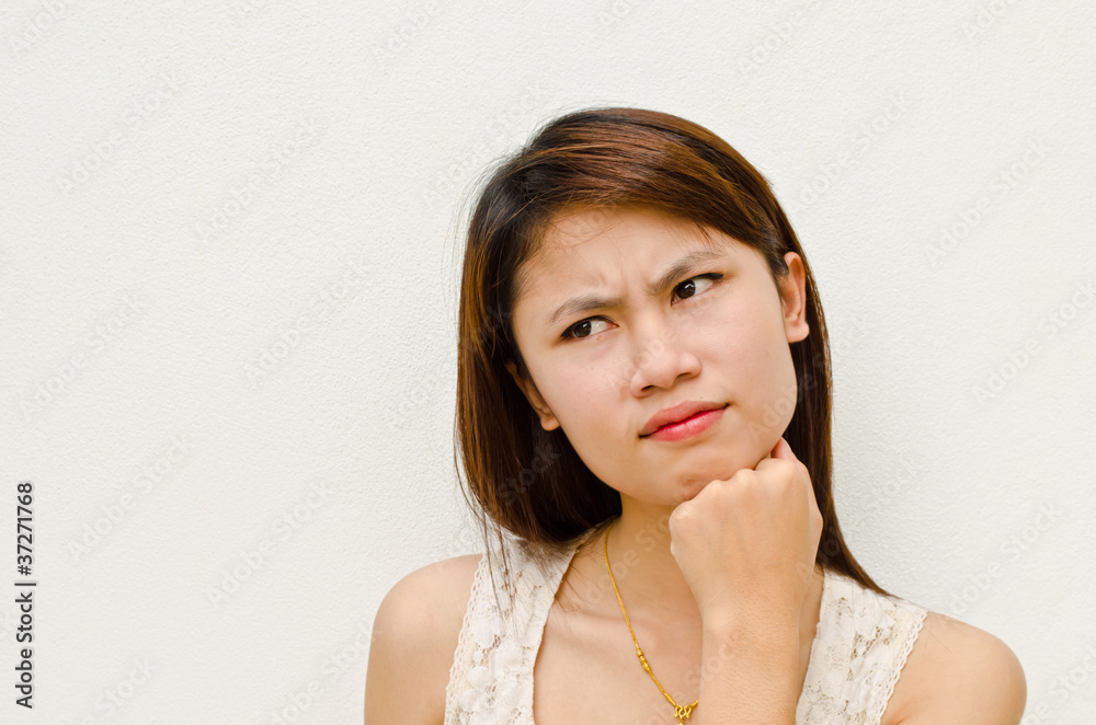 young cute asian girl thinking on white background young cute asian girl thinking on white background