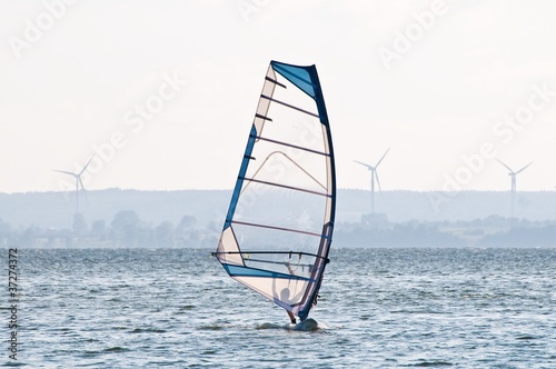 Windsurfer with wind turbines in the background