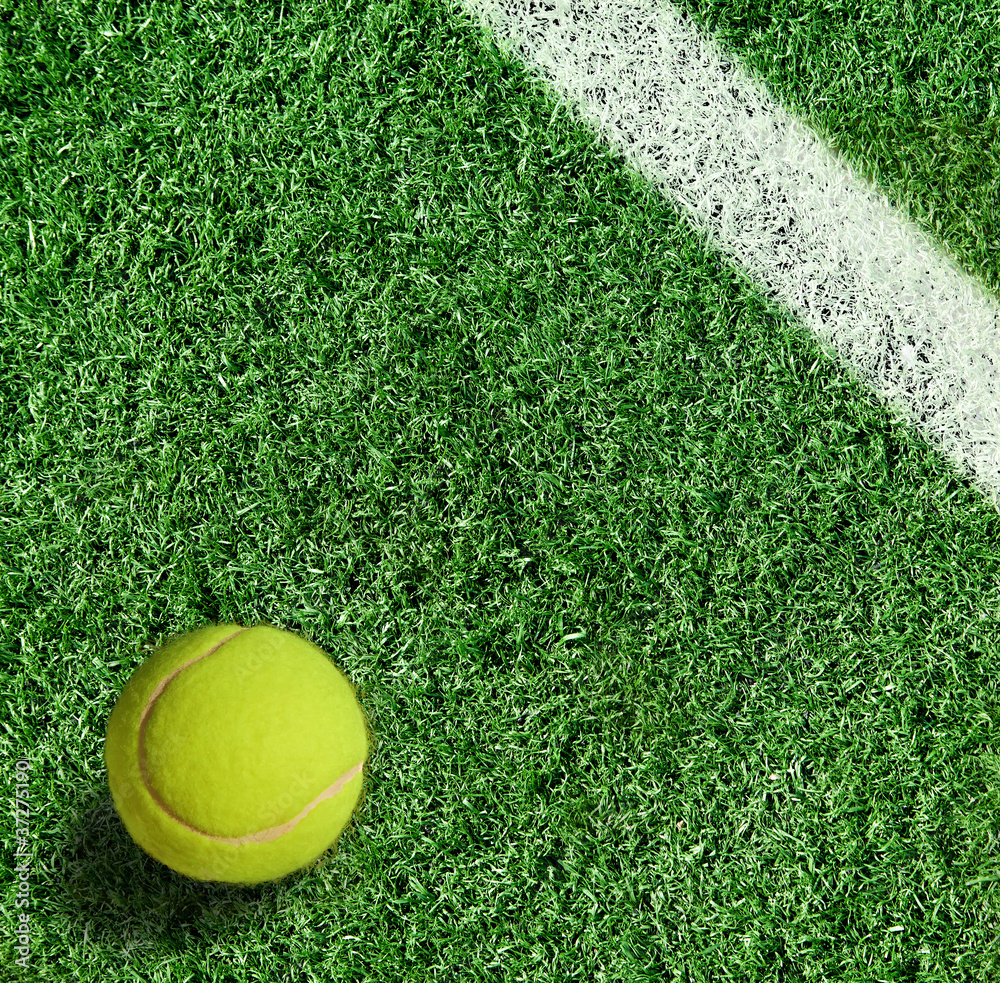 yellow tennis ball on green grass