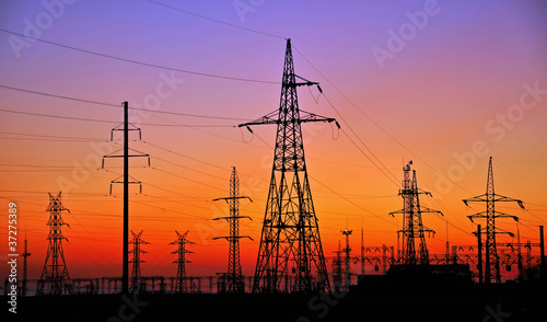 ELECTRICITY PYLONS AGAINST SUNSET photo