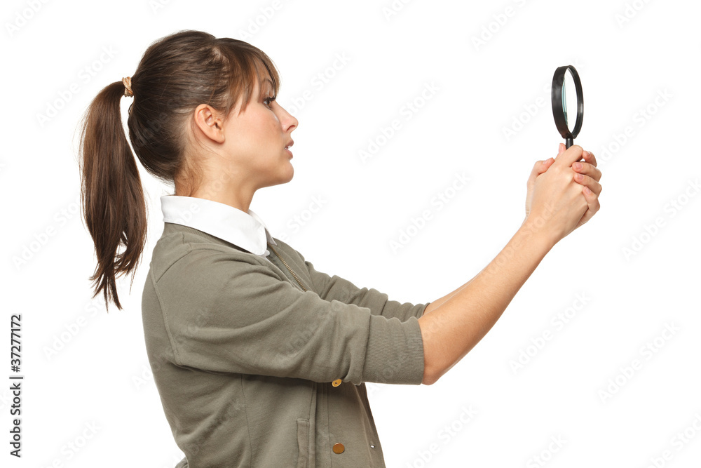 Side view o female looking with magnifying glass Side view o female looking with magnifying glass