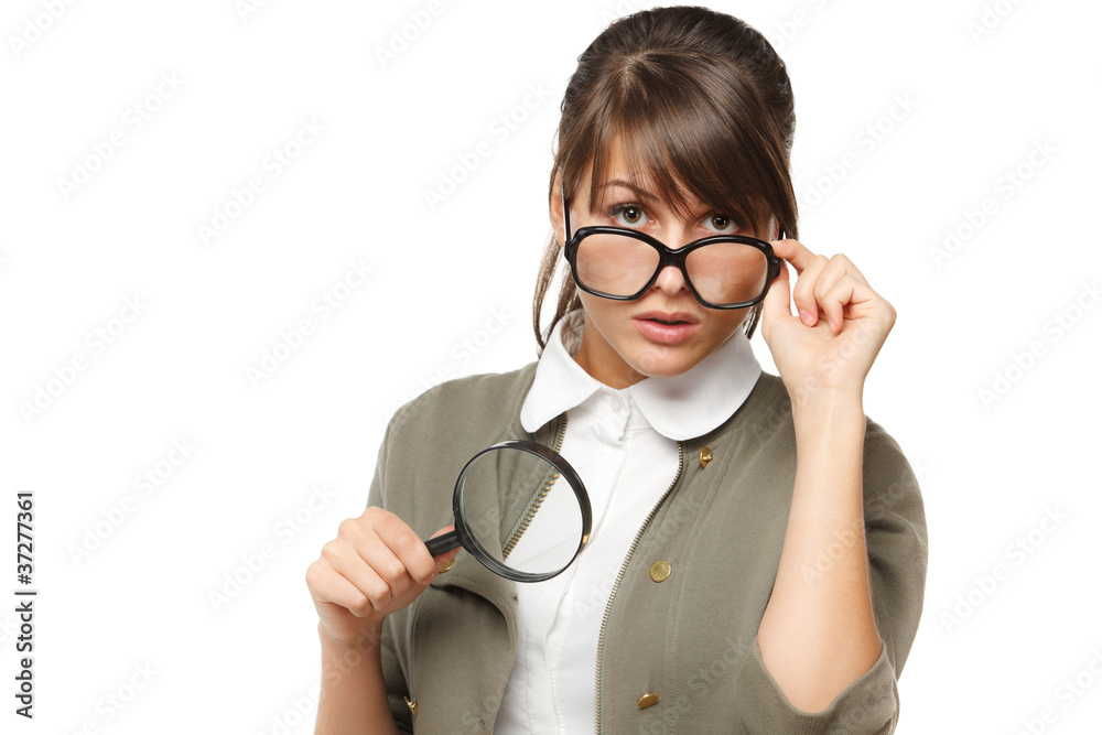Woman wearing old fashioned eyeglasses holding loupe Woman wearing old fashioned eyeglasses holding loupe