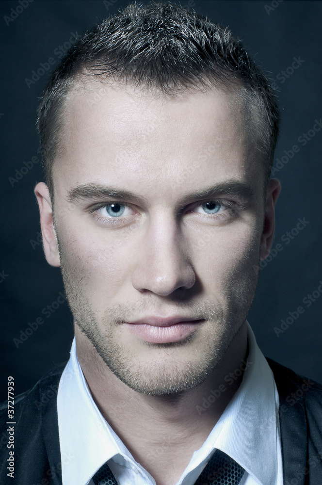 Obraz premium Close-up portrait of young handsome man with green eyes