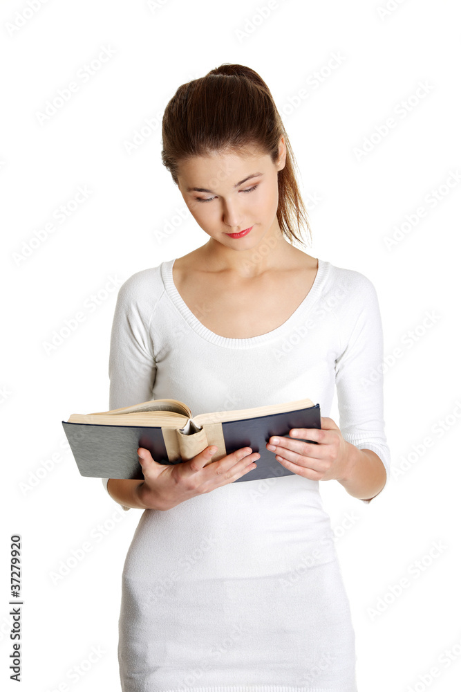 Portrait of a beautiful young caucasian teen reading a book. Portrait of a beautiful young caucasian teen reading a book.