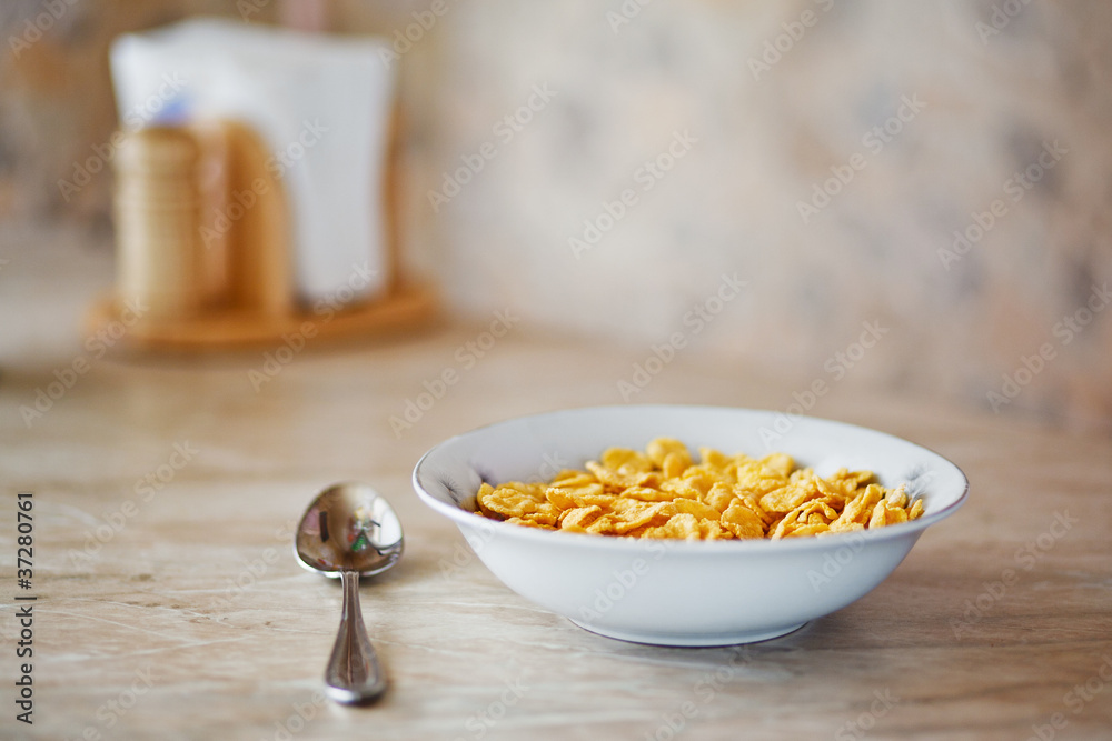 bowl of corn flakes and spoon bowl of corn flakes and spoon