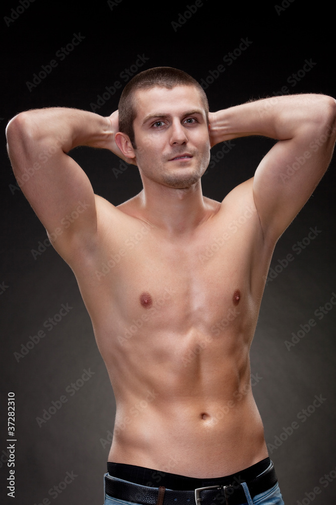Young muscular man showing his muscles