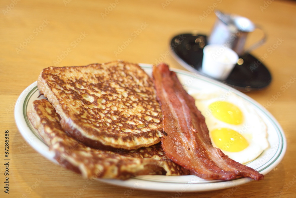 Delicious French toast with bacon and eggs for breakfast. Delicious French toast with bacon and eggs for breakfast.