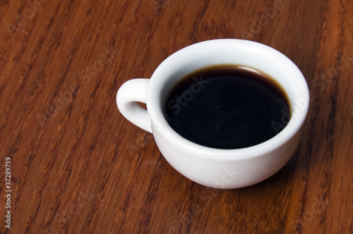 Small porcelain cup with coffee