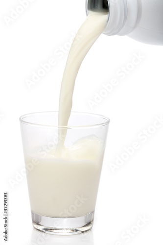 Bottle pouring milk into a glass. Splash