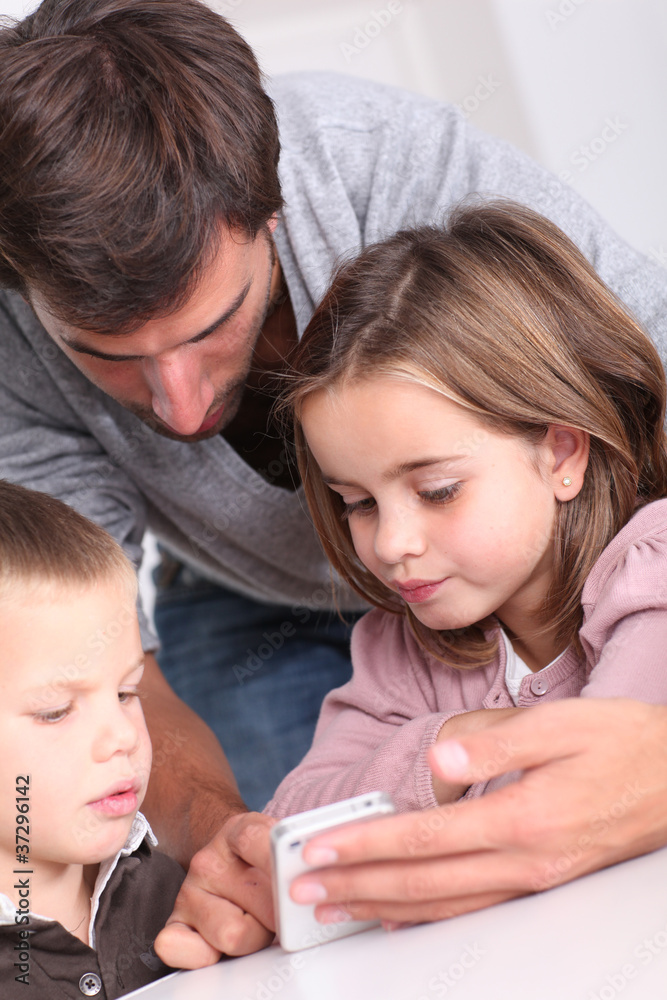 Father and children playing with smartphone Father and children playing with smartphone