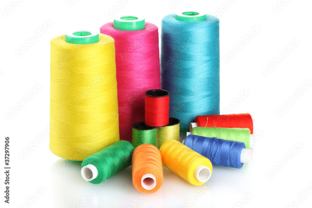 Many-coloured bobbins of thread isolated on white Many-coloured bobbins of thread isolated on white