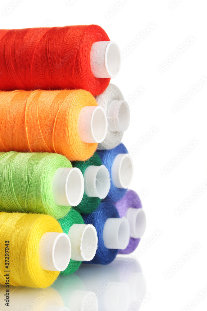 Pyramid of many-coloured bobbins of thread isolated on white Pyramid of many-coloured bobbins of thread isolated on white