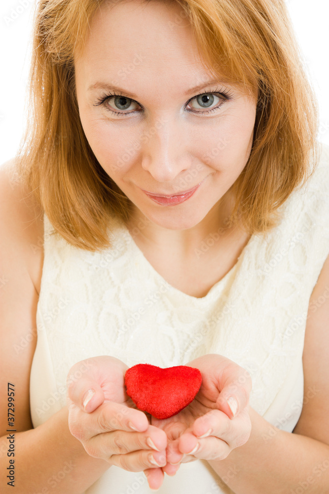 A girl holds a heart in the palms on a white background. A girl holds a heart in the palms on a white background.