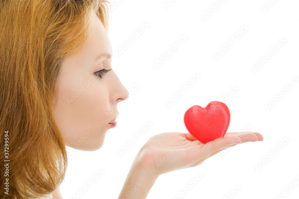 The girl sends an air kiss in the form of heart The girl sends an air kiss in the form of heart