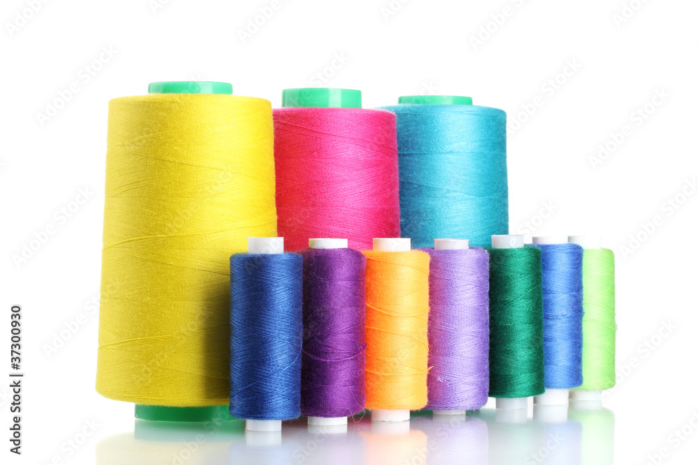 Many-coloured bobbins of thread isolated on white Many-coloured bobbins of thread isolated on white