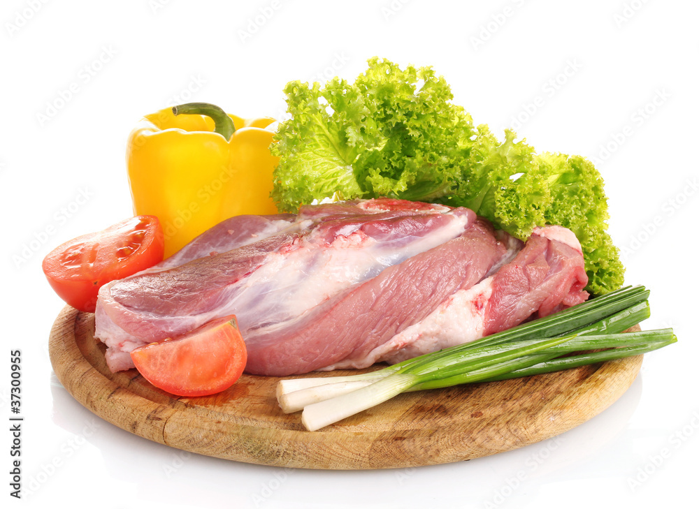 Raw meat and vegetables on a wooden board isolated on whitе Raw meat and vegetables on a wooden board isolated on whitе