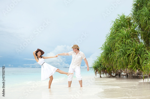 Young couple on the beach of sea