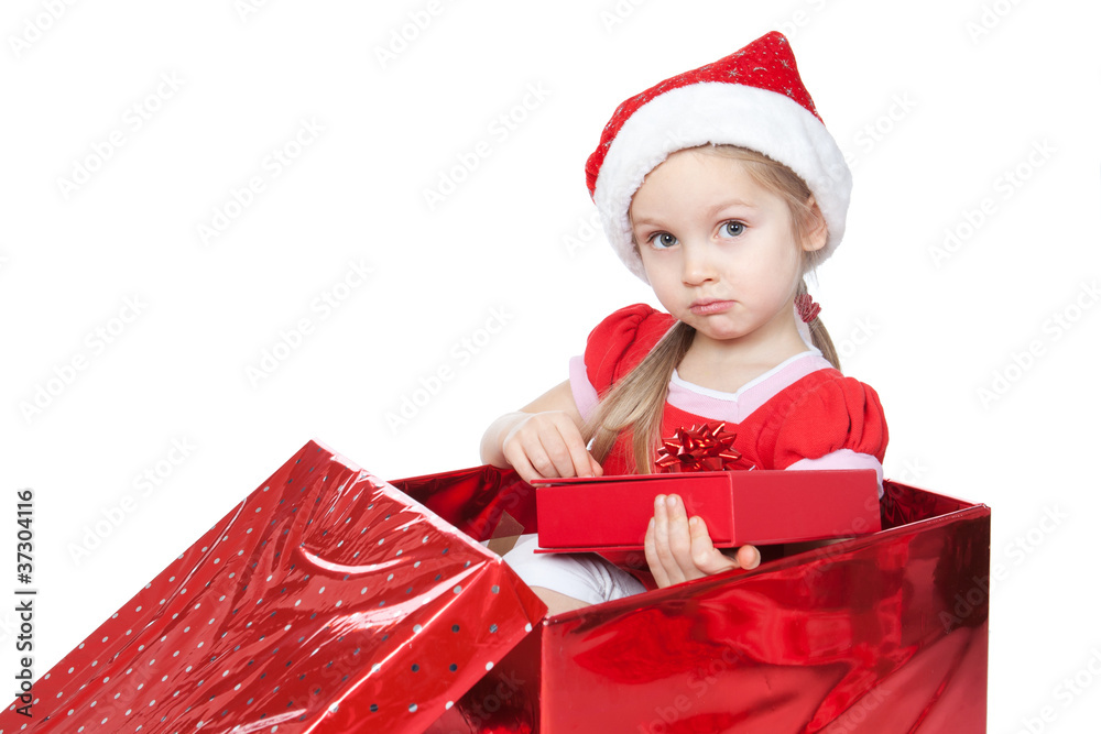 Little girl sitting in a large Christmas present box over white Little girl sitting in a large Christmas present box over white
