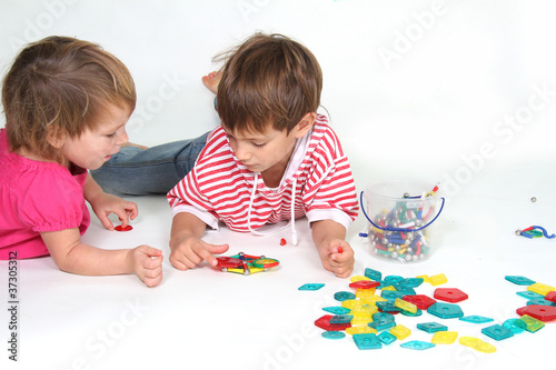 two children playing studio shot photo