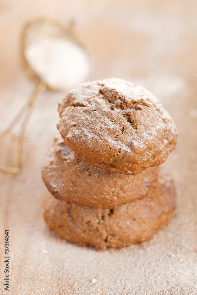 soft ginger cookies three stacked and dusted on wooden table soft ginger cookies three stacked and dusted on wooden table