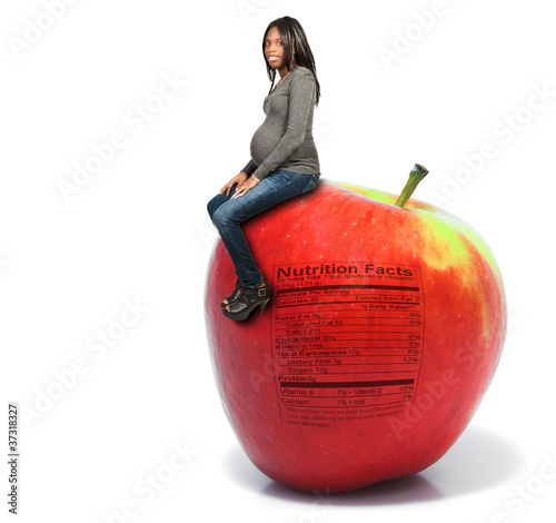 Pregnant Woman with Apple with Nutrition Label photo