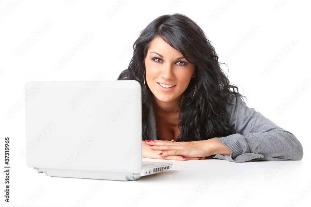 Beautiful young girl laying on the floor using a laptop Beautiful young girl laying on the floor using a laptop