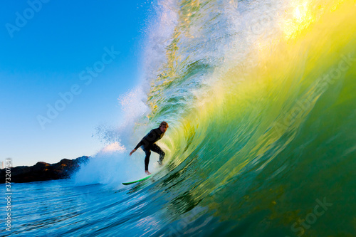 Surfer on Wave at Sunset © EpicStockMedia