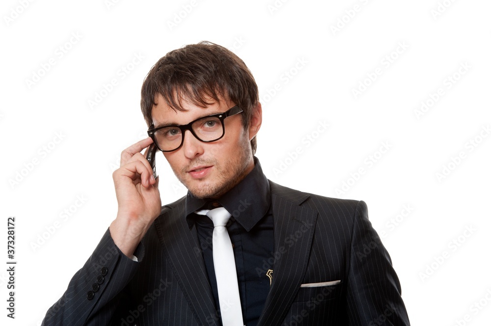 Handsome young man talking on a phone. Handsome young man talking on a phone.