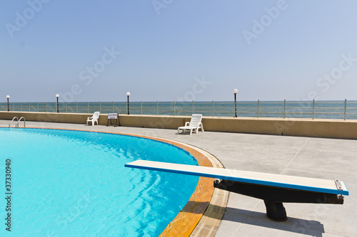 springboard on swimming pool photo