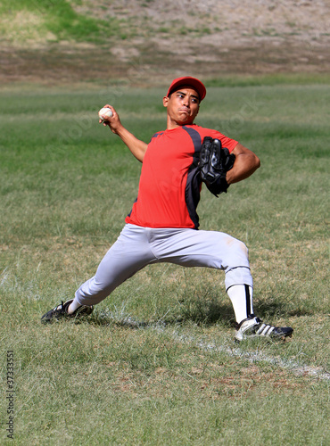 Obraz na płótnie Baseball player throws a ball down the line with force