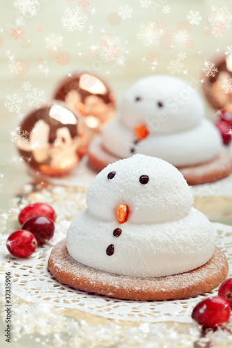 Two marshmallow snowmen biscuits with Christmas decorations