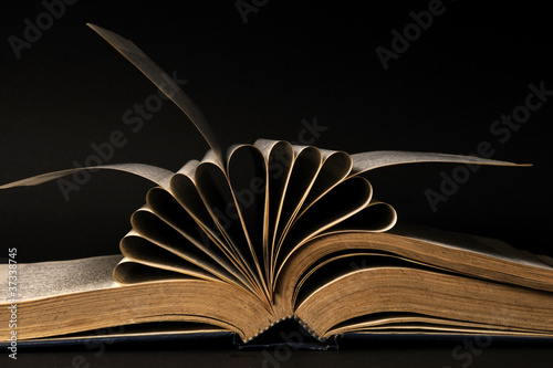 pages of dictionary isolated on black background photo