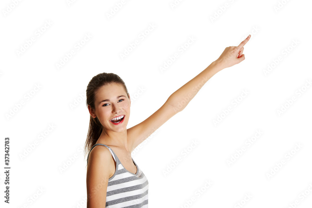 Female caucasian teen pointing up with a finger. Female caucasian teen pointing up with a finger.