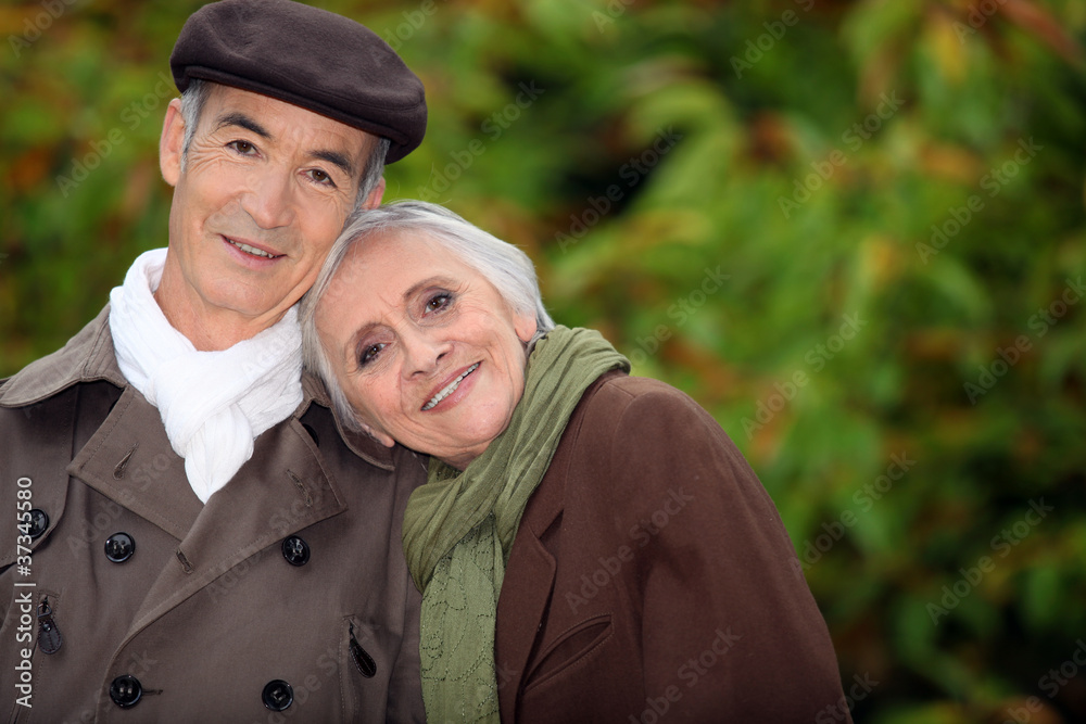 A mature couple in a park. A mature couple in a park.