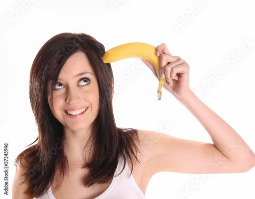 Beautiful young laughing woman with banana