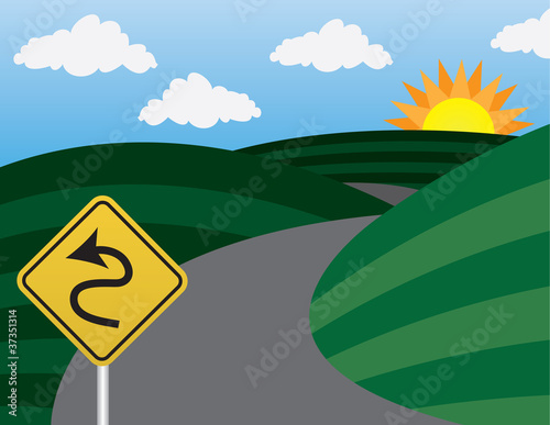 Curvy road and hills with warning sign