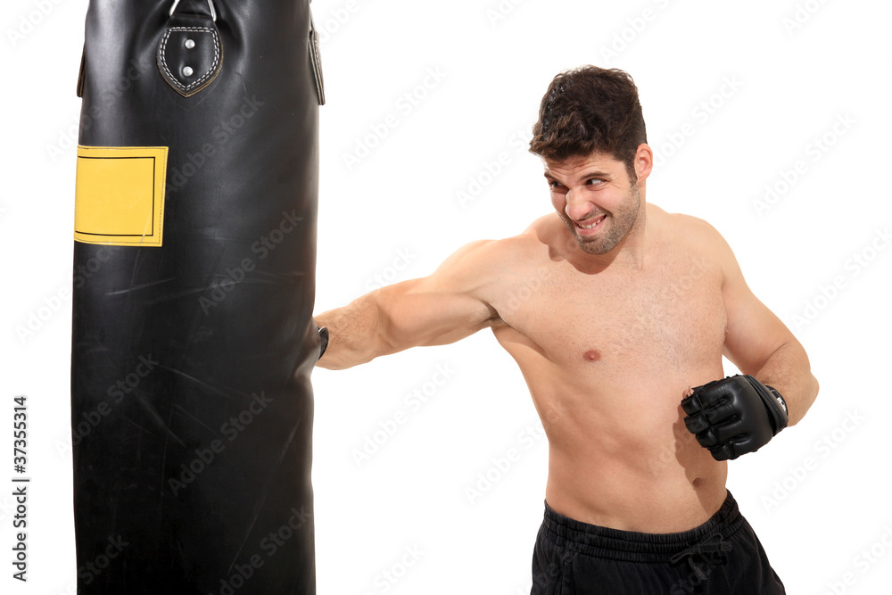 young boxer exercising on boxing bag