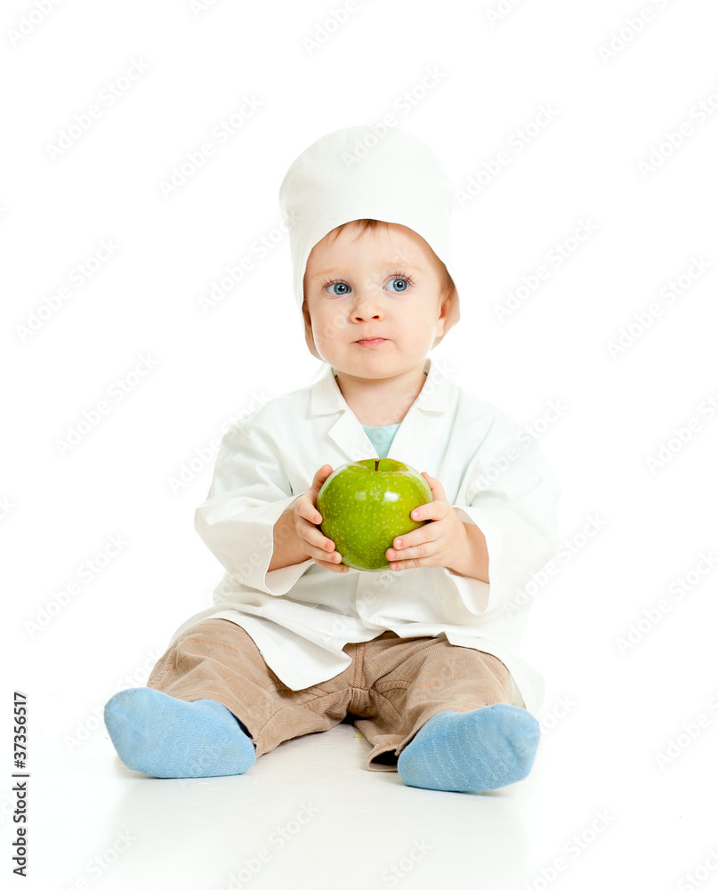 Adorable boy uniformed as doctor with green apple over white Adorable boy uniformed as doctor with green apple over white