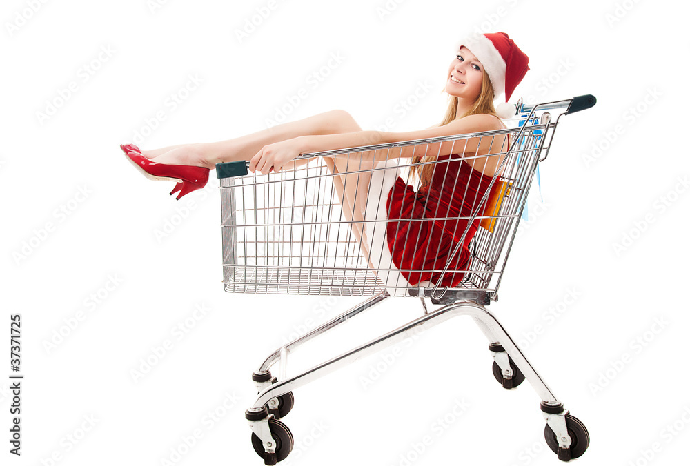 Christmas woman in santa hat sitting in shopping cart over white Christmas woman in santa hat sitting in shopping cart over white