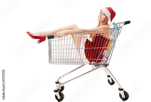 Christmas woman in santa hat sitting in shopping cart over white © yuriyzhuravov