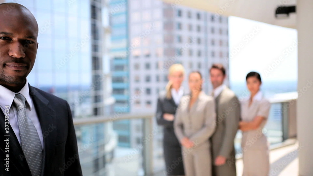 African American Businessman in Portrait with Colleagues African American Businessman in Portrait with Colleagues