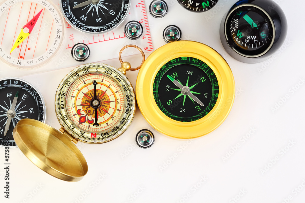group of twelve different small and big compasses on white group of twelve different small and big compasses on white