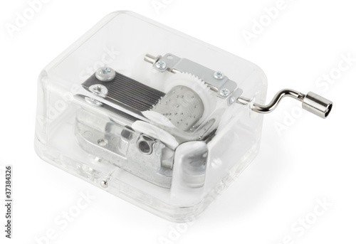 little clockwork toy transparent musical box on white