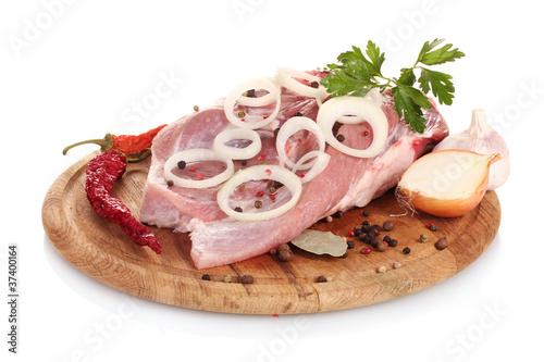 Raw meat and onion on a wooden board isolated on white